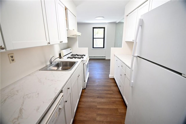 kitchen with under cabinet range hood, white appliances, a sink, white cabinetry, and dark wood-style floors