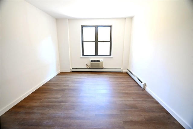 spare room with dark wood-style floors, baseboards, a baseboard heating unit, and an AC wall unit