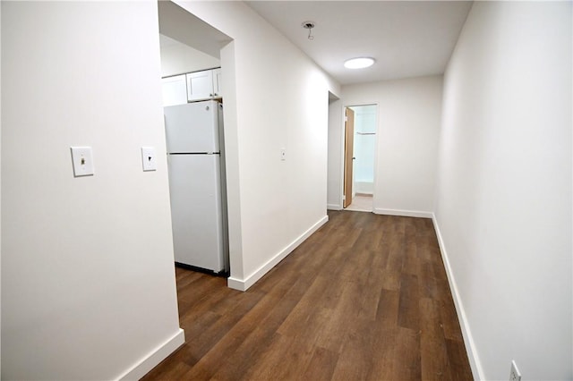 hall featuring dark wood finished floors and baseboards