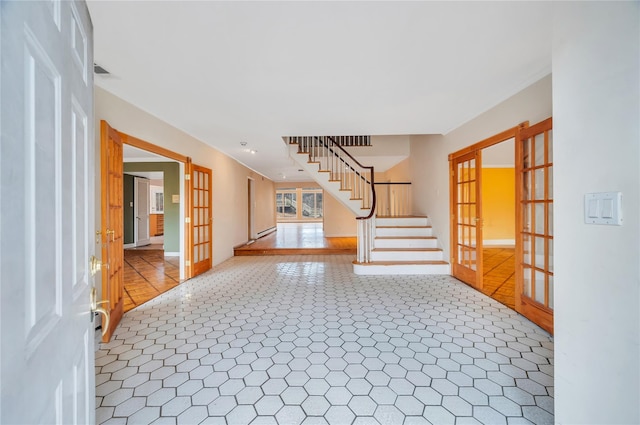 foyer with baseboards, stairs, visible vents, and french doors