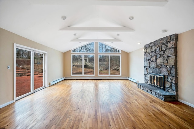 unfurnished living room with wood-type flooring, lofted ceiling with beams, baseboard heating, a stone fireplace, and baseboards