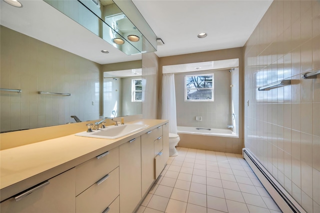 full bath featuring a baseboard radiator, toilet, vanity, tile patterned floors, and shower / bath combo