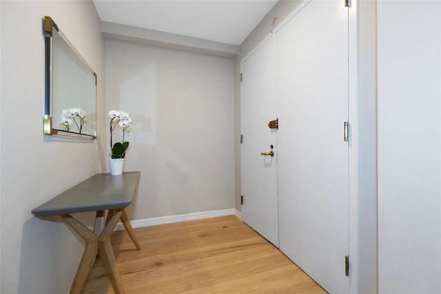 entryway with light wood-type flooring and baseboards