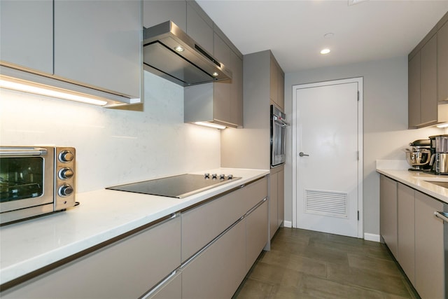 kitchen featuring black electric stovetop, visible vents, stainless steel oven, gray cabinets, and wall chimney exhaust hood