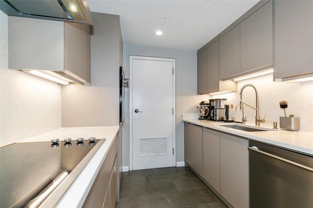 kitchen featuring a sink, light countertops, stainless steel dishwasher, and gray cabinets