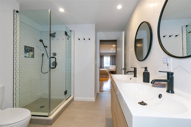 full bath with tile patterned flooring, a sink, toilet, and a shower stall