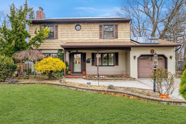 view of front of home with solar panels, concrete driveway, a chimney, an attached garage, and a front lawn