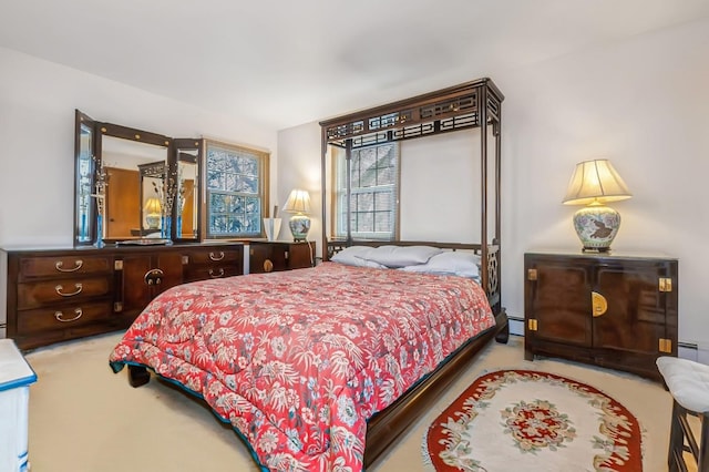 carpeted bedroom featuring a baseboard heating unit