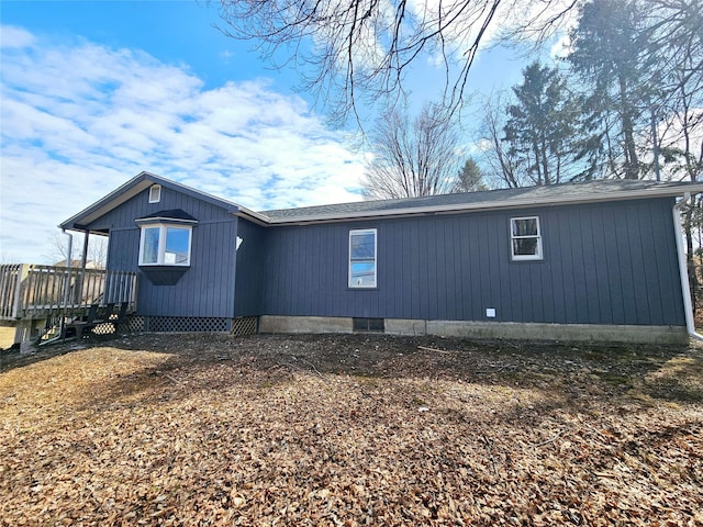 view of side of property with a wooden deck