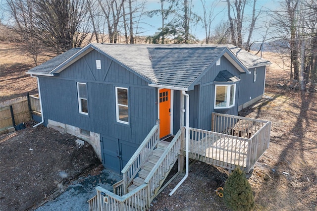 view of front of home featuring a shingled roof and fence