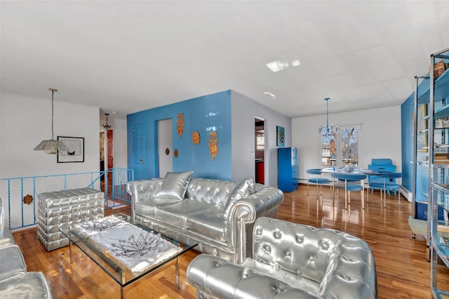 living area featuring a notable chandelier and wood finished floors