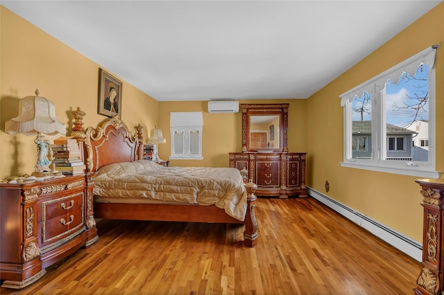 bedroom with wood finished floors, baseboard heating, and a wall mounted AC