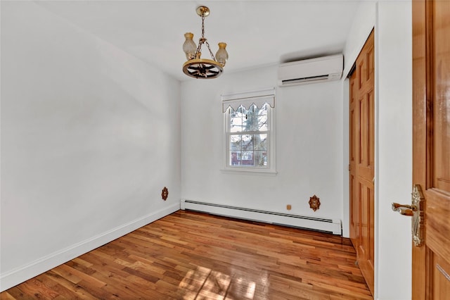 unfurnished dining area featuring light wood finished floors, a baseboard radiator, a wall unit AC, and baseboards