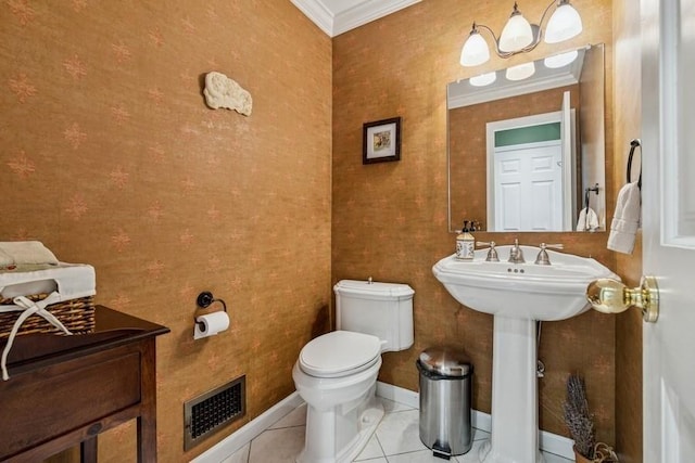 bathroom with visible vents, baseboards, crown molding, tile patterned floors, and toilet