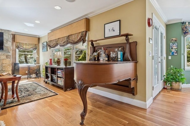 interior space featuring recessed lighting, crown molding, baseboards, and wood finished floors