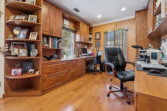 home office with visible vents, crown molding, light wood-type flooring, recessed lighting, and built in study area