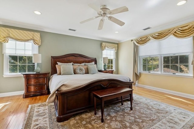 bedroom with visible vents, multiple windows, and ornamental molding