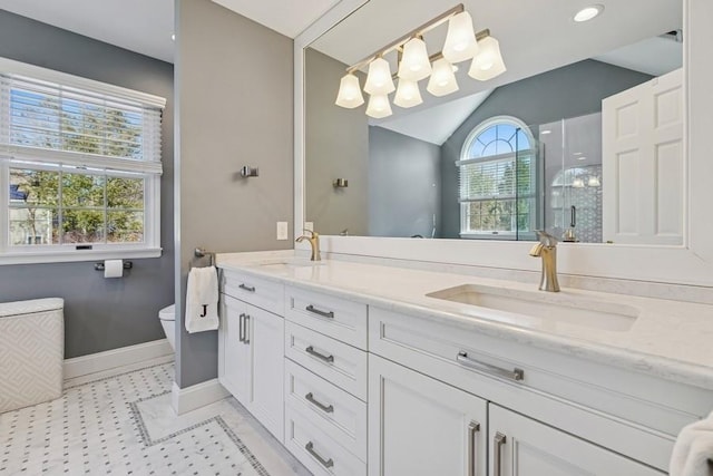 full bath featuring double vanity, vaulted ceiling, a shower stall, and a sink