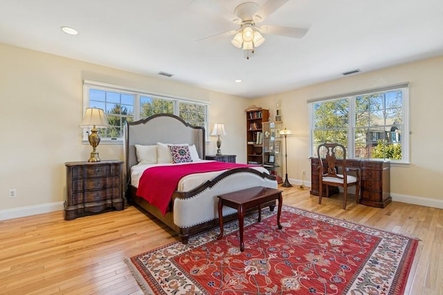 bedroom with visible vents, baseboards, and hardwood / wood-style floors