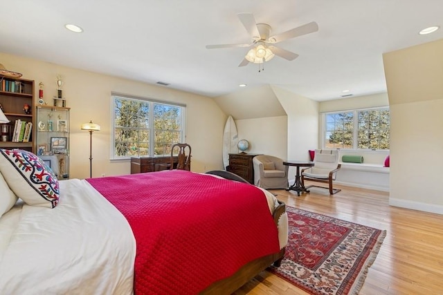 bedroom with recessed lighting, multiple windows, and wood finished floors