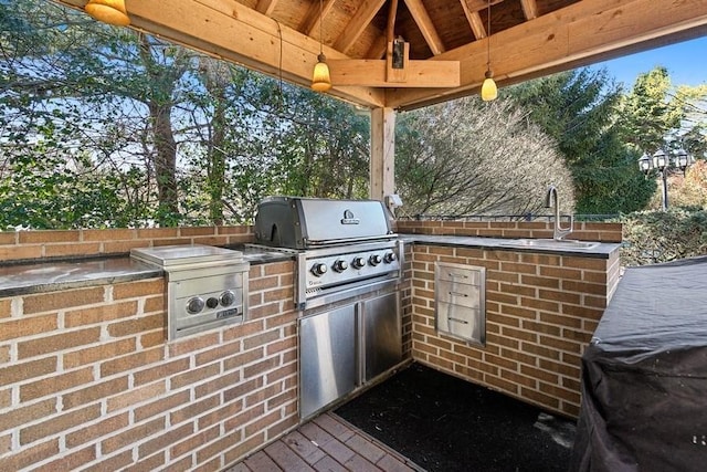 view of patio / terrace featuring area for grilling and a sink