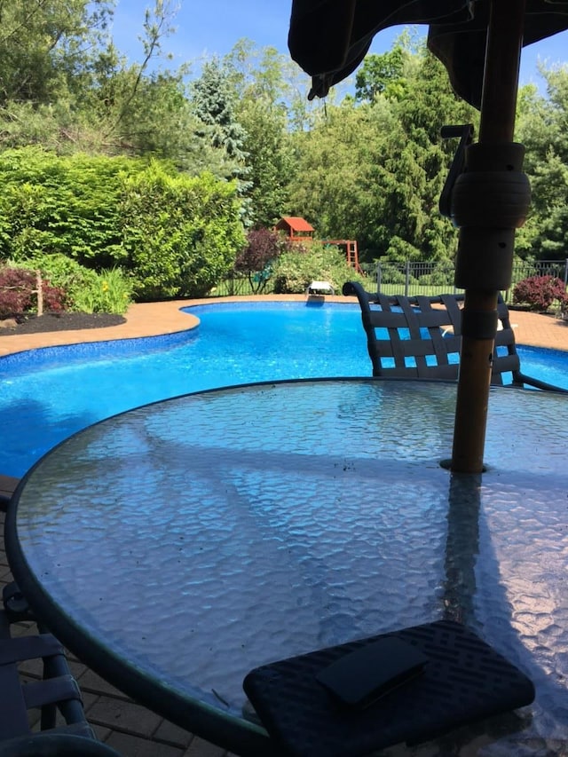 view of swimming pool with fence and a fenced in pool