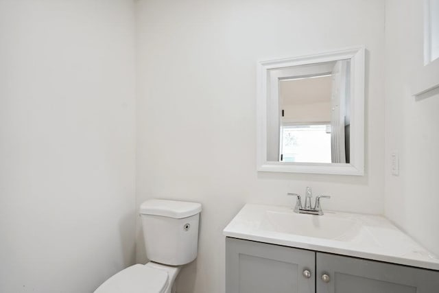 half bath with vanity and toilet