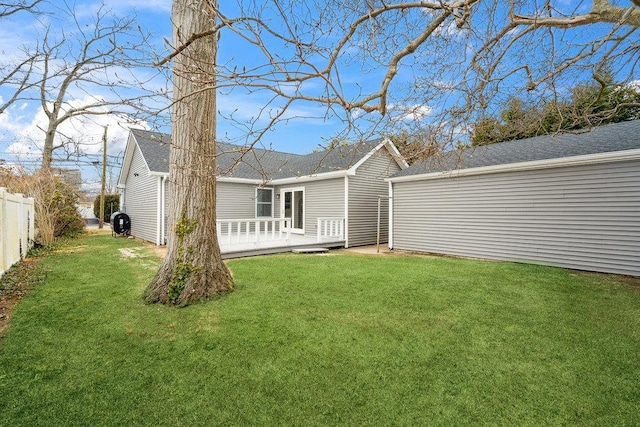 back of house with a lawn, fence, and a wooden deck