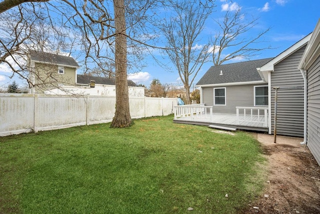 view of yard featuring fence and a deck