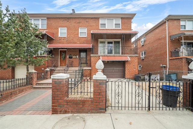 view of front of house with driveway, a fenced front yard, and brick siding