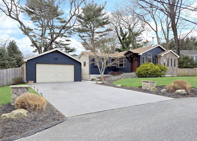 ranch-style home featuring a garage, an outbuilding, fence, and a front lawn