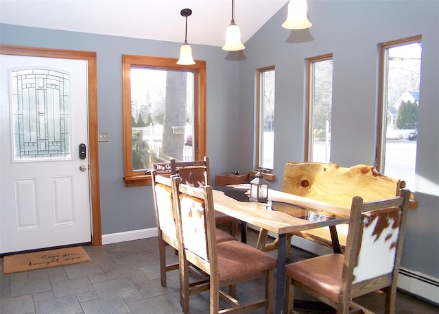 dining room with vaulted ceiling, baseboards, and baseboard heating