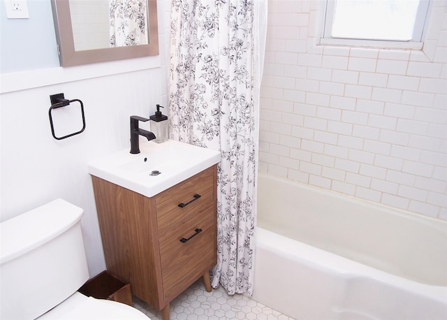 bathroom featuring toilet, tile patterned flooring, shower / bath combo, and vanity