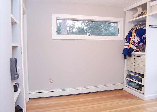 mudroom with light wood-style flooring and baseboard heating