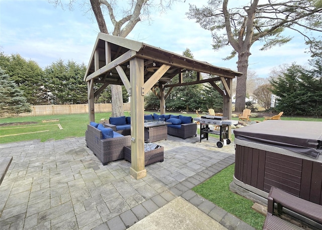 view of patio with a hot tub, a gazebo, grilling area, fence, and an outdoor living space