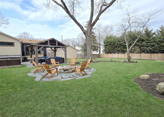 view of yard with a patio, a hot tub, a gazebo, a fenced backyard, and a fire pit