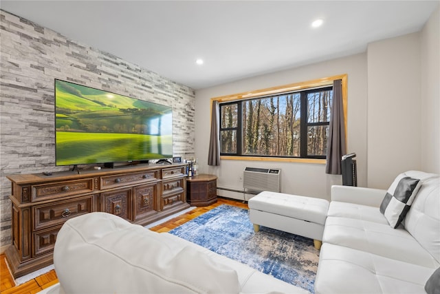 living area featuring an AC wall unit, baseboard heating, and recessed lighting