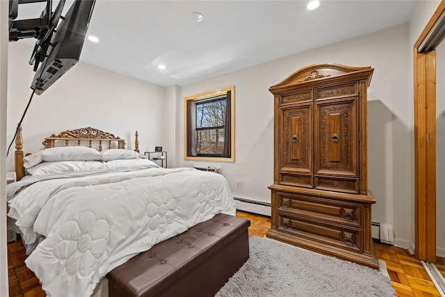 bedroom with a baseboard heating unit and recessed lighting