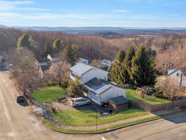 birds eye view of property featuring a view of trees and a mountain view