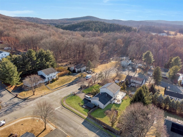 drone / aerial view featuring a mountain view and a forest view