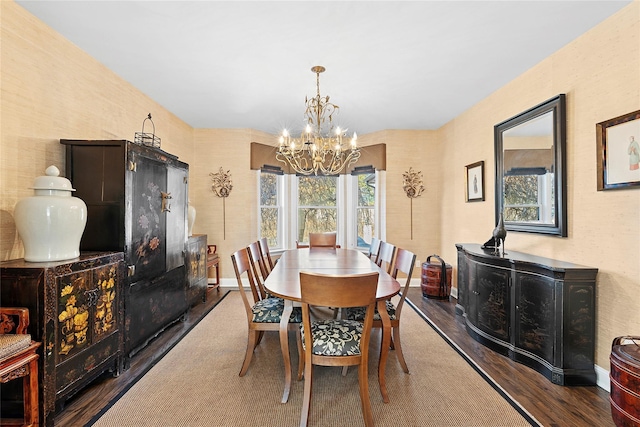 dining room featuring an inviting chandelier, baseboards, and wood finished floors