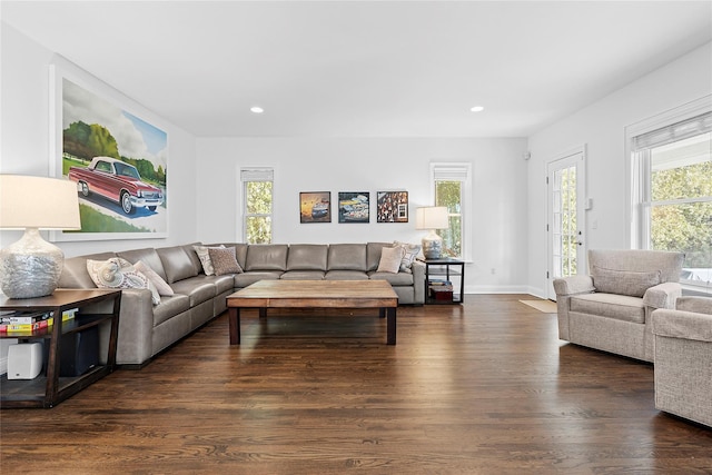 living area featuring baseboards, dark wood-type flooring, plenty of natural light, and recessed lighting