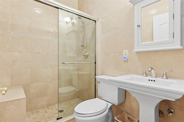 bathroom with toilet, tasteful backsplash, a shower stall, and tile walls