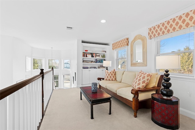 interior space with light carpet, visible vents, and recessed lighting