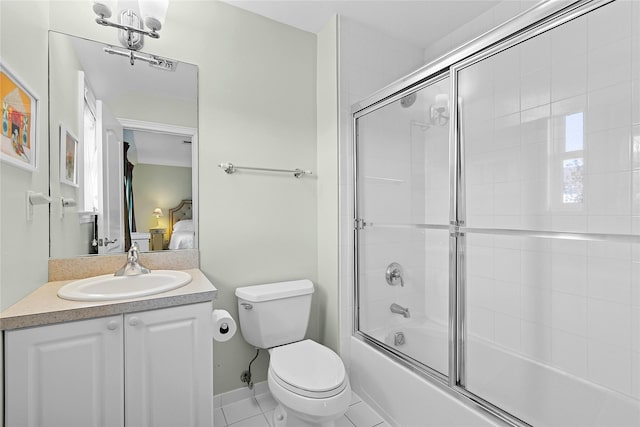 full bathroom with toilet, ensuite bathroom, combined bath / shower with glass door, vanity, and tile patterned floors