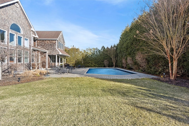 pool with a patio and a yard