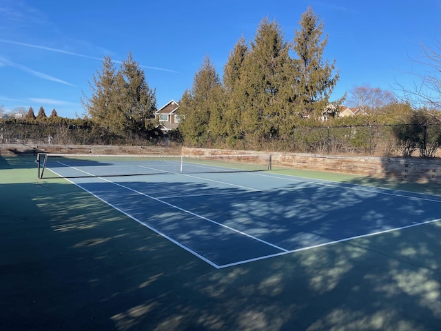 view of sport court featuring fence