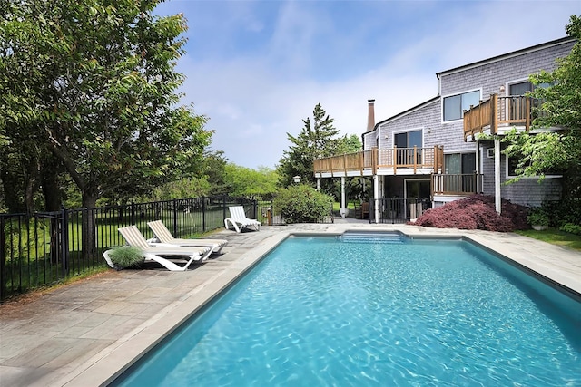 view of swimming pool featuring a patio area, fence, and a fenced in pool