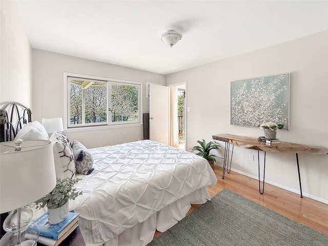 bedroom featuring wood finished floors and baseboards