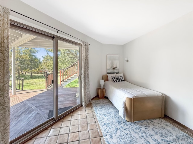 bedroom with light tile patterned floors and access to exterior